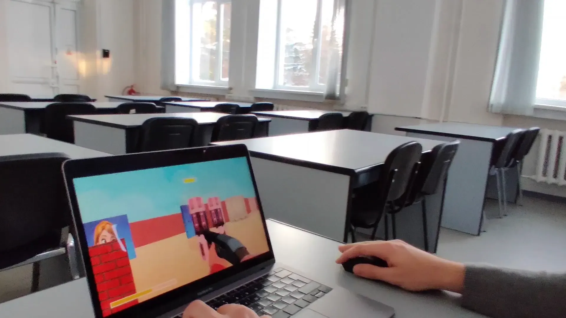 A player testing the pseudo-3D shooter on a laptop during the first multiplayer session