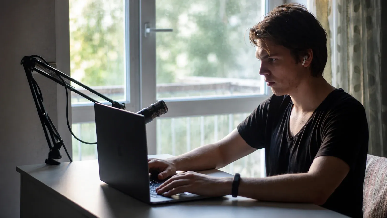 Ivan Ilin building the early Vectozavr Academy at a laptop beside a microphone